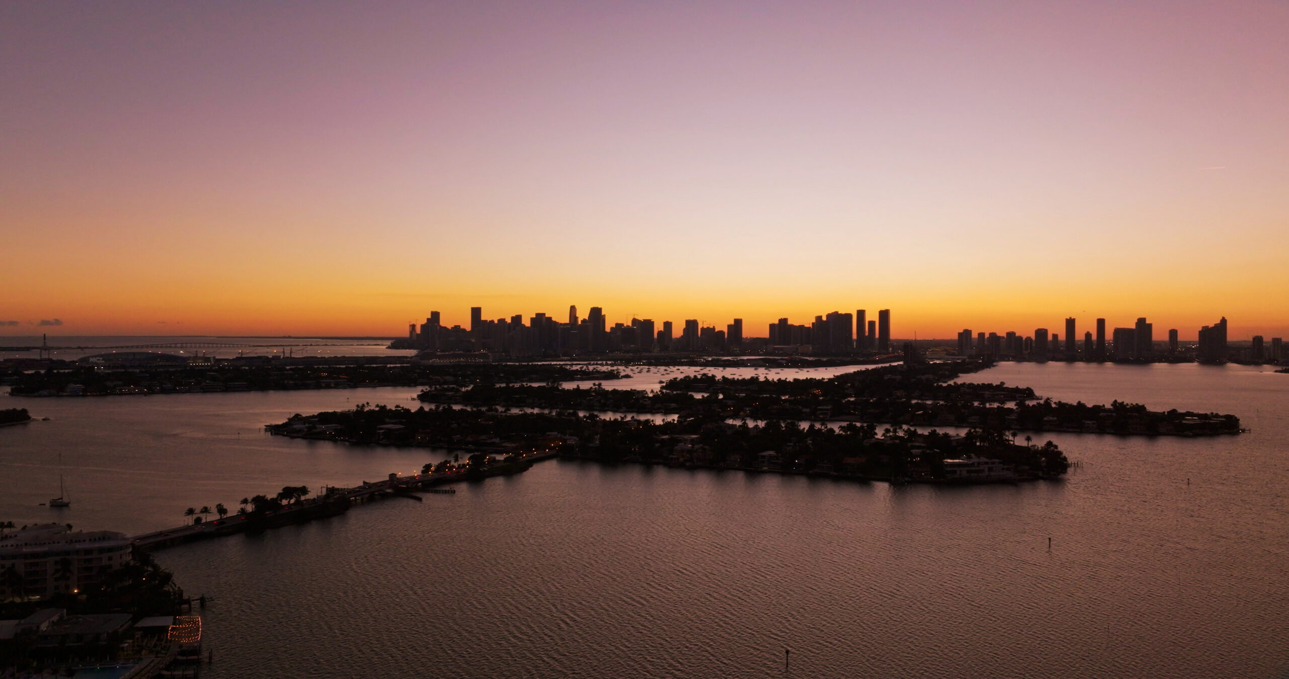 Miami cityscape silhouette at sunset over biscayne bay Biscayne Bay boat tour Miami